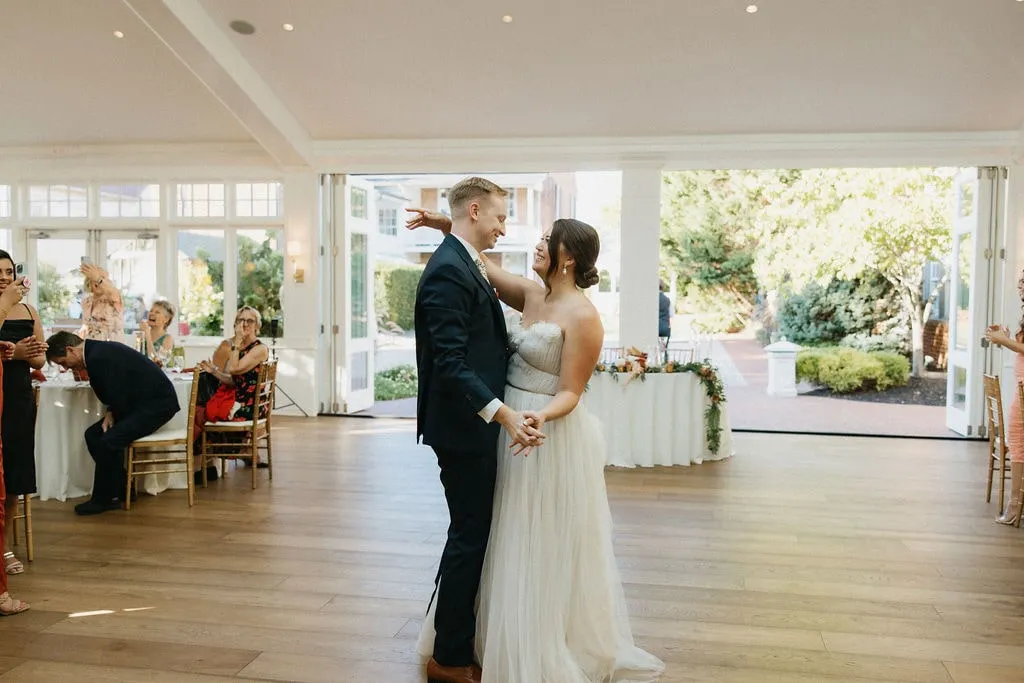 bride and groom first dance in front of sweetheart table