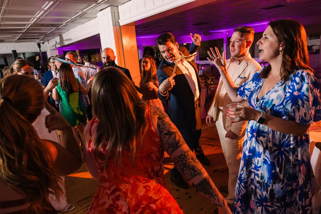 wedding guests dancing in a colorful room