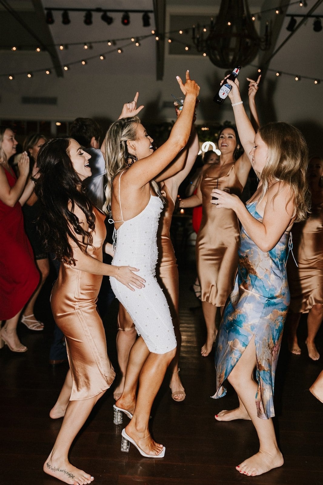 bride, bridesmaid, and other woman dance