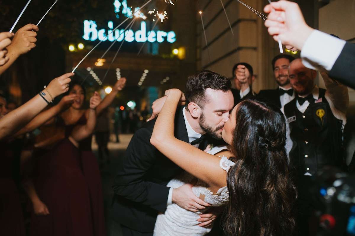bride and groom kiss during sparkler exit