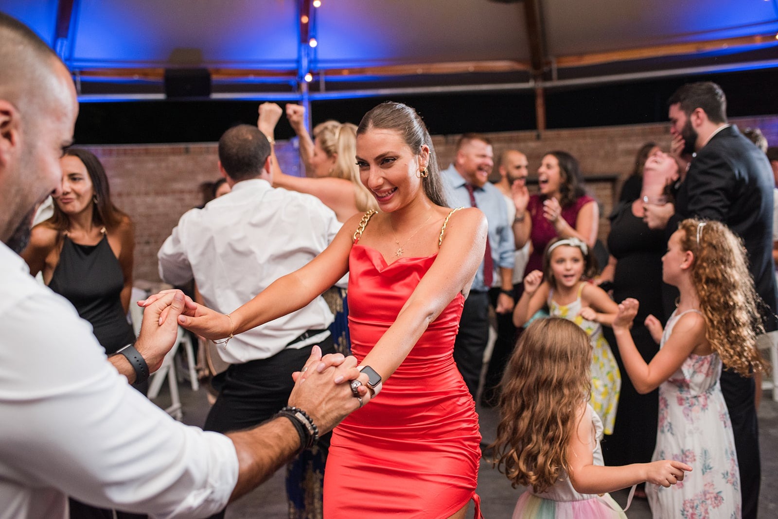 woman in red dress dancing at wedding