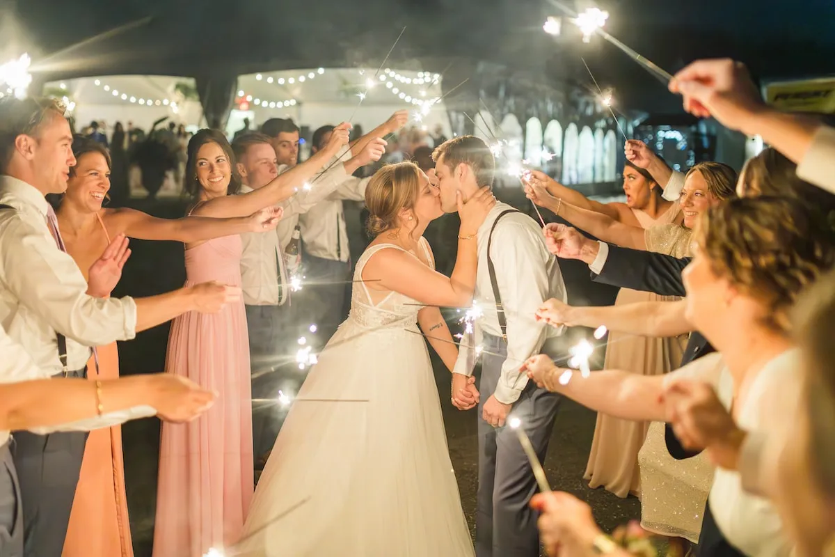 bride and groom kiss during sparkler exit