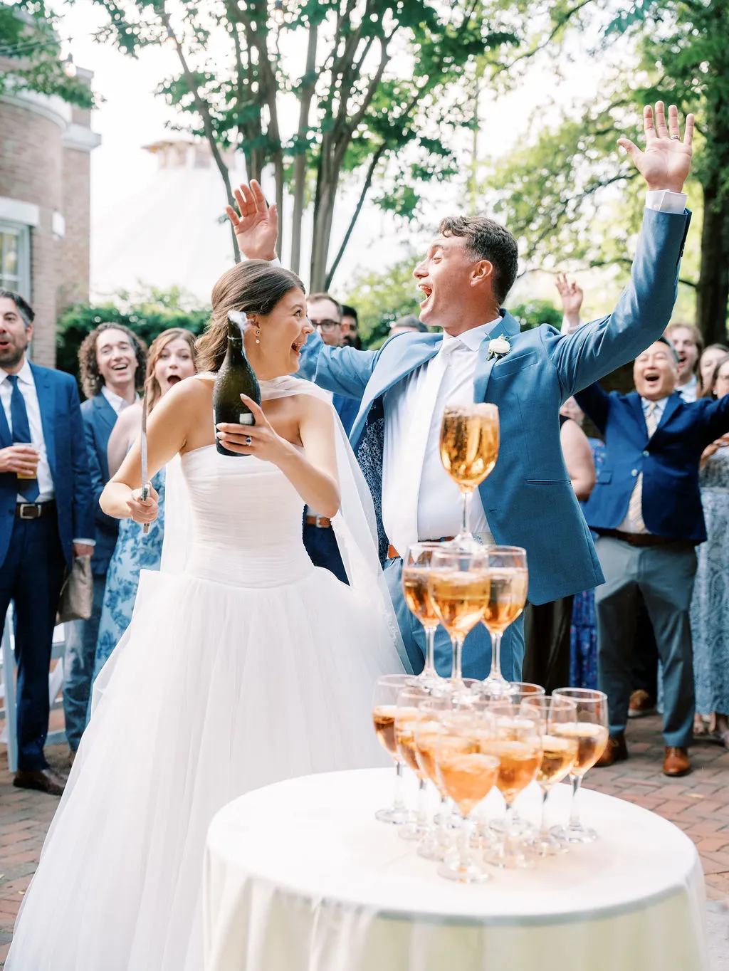 bride and groom pouring a champagne tower