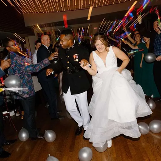 bride and groom holding hands while exiting wedding