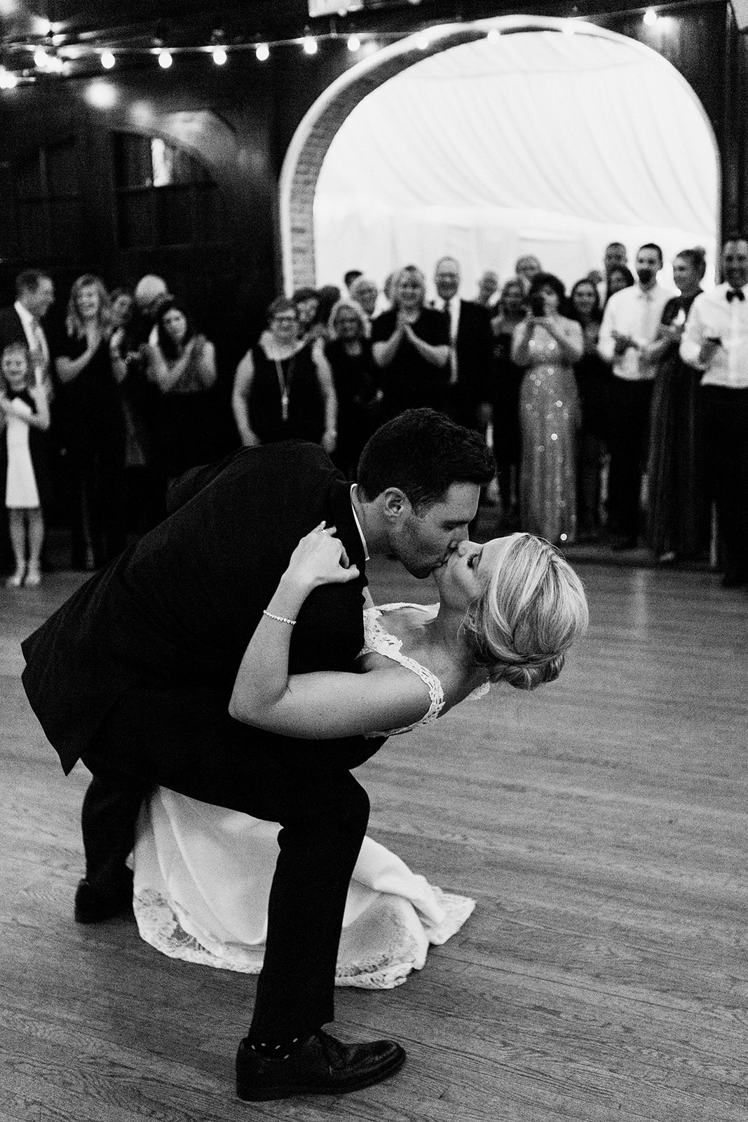 groom dipping and kissing bride during first dance