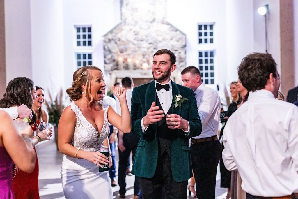 bride and groom dancing at wedding with guests