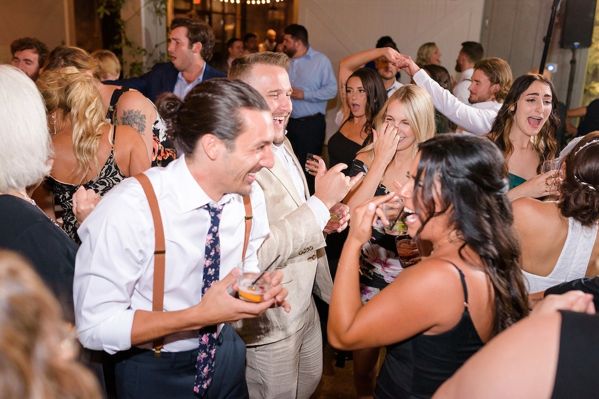 guests dancing and smiling at wedding