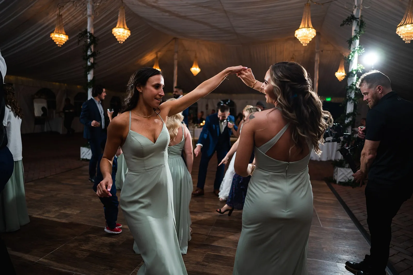 bridesmaids dancing with each other at wedding