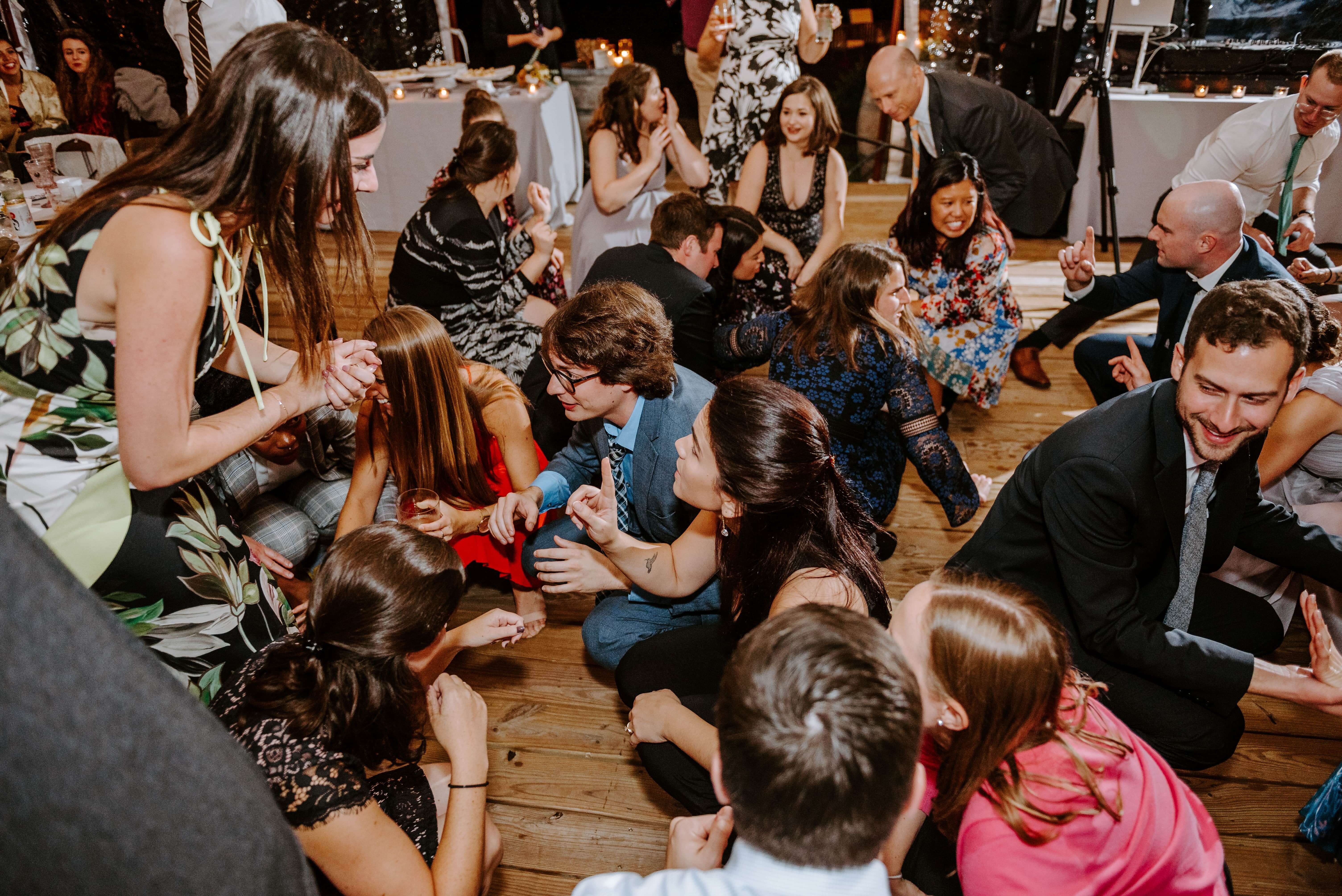 guests crouch down on the dance floor