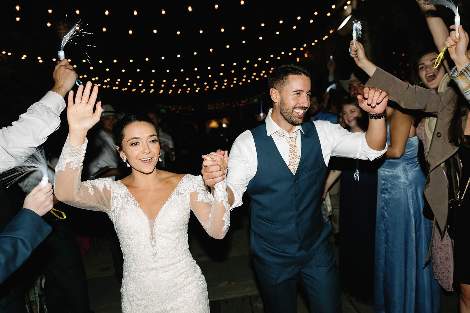 bride and groom hold hands while doing wedding exit outside