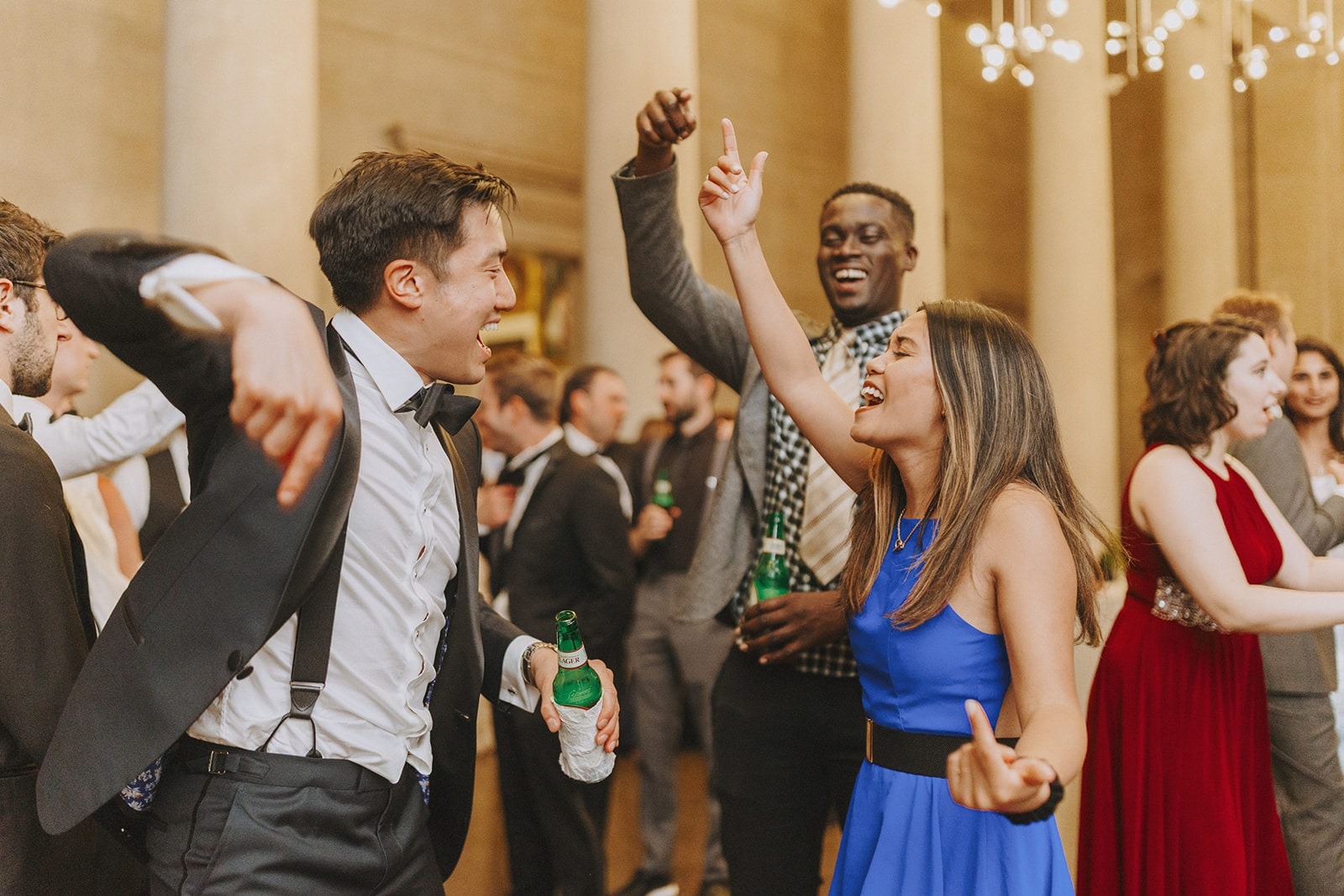 guy in tux and woman in blue dress dancing at wedding