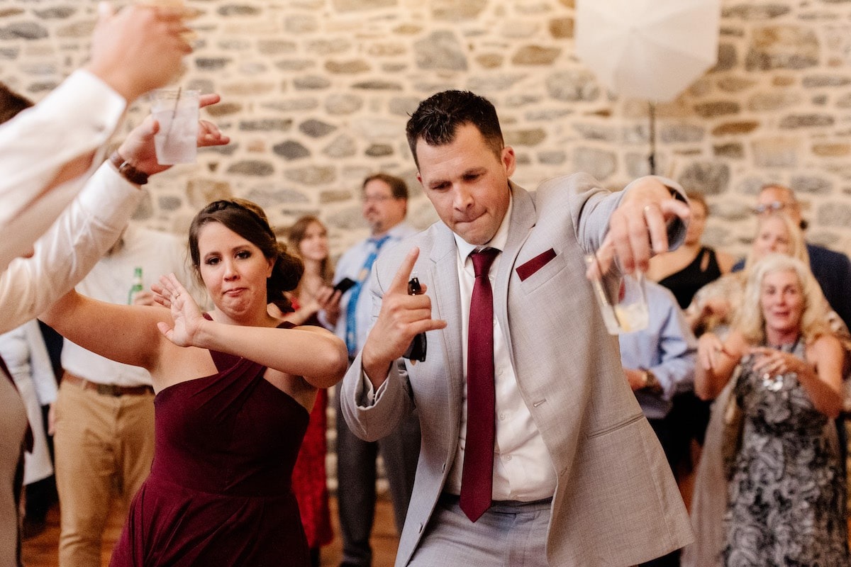 bridesmaid and groomsman dancing