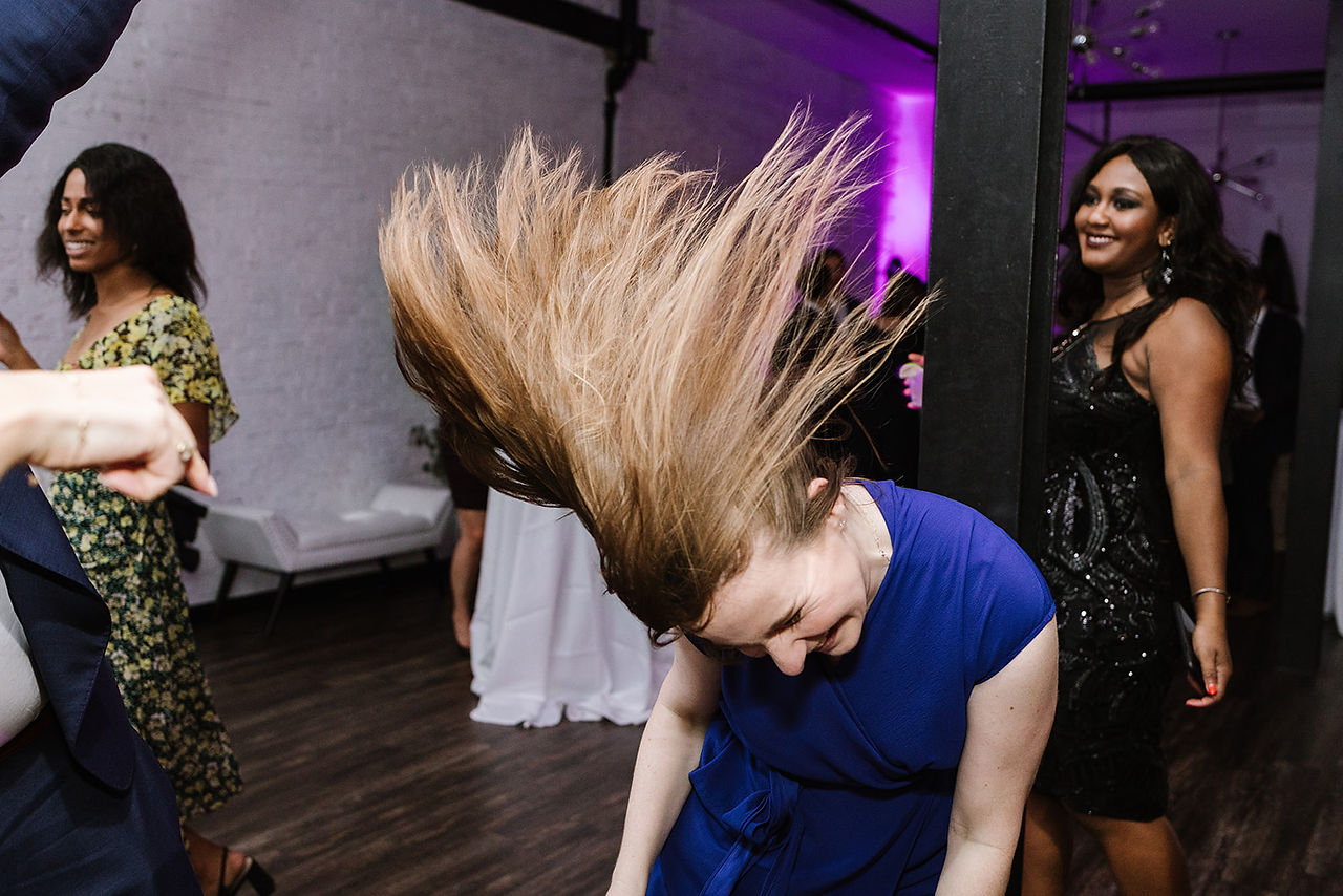 woman flips her hair while dancing