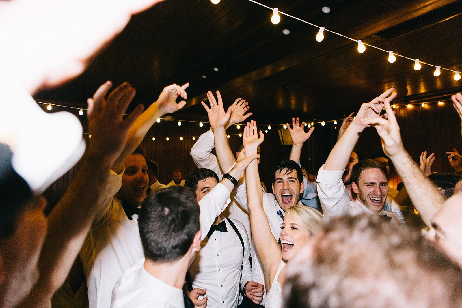 wedding guests dancing with hands up