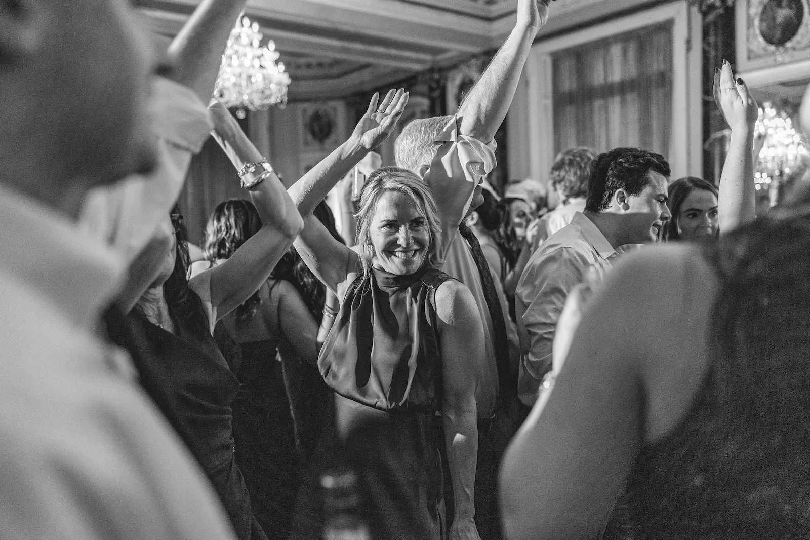 woman dancing at wedding with arm up