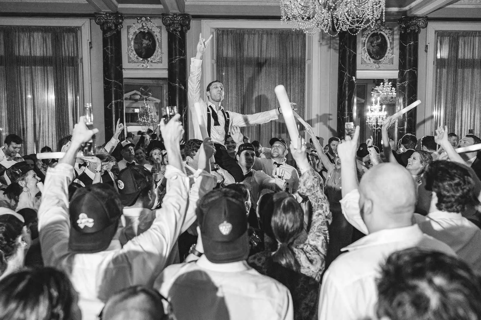wedding guests dancing with hands up