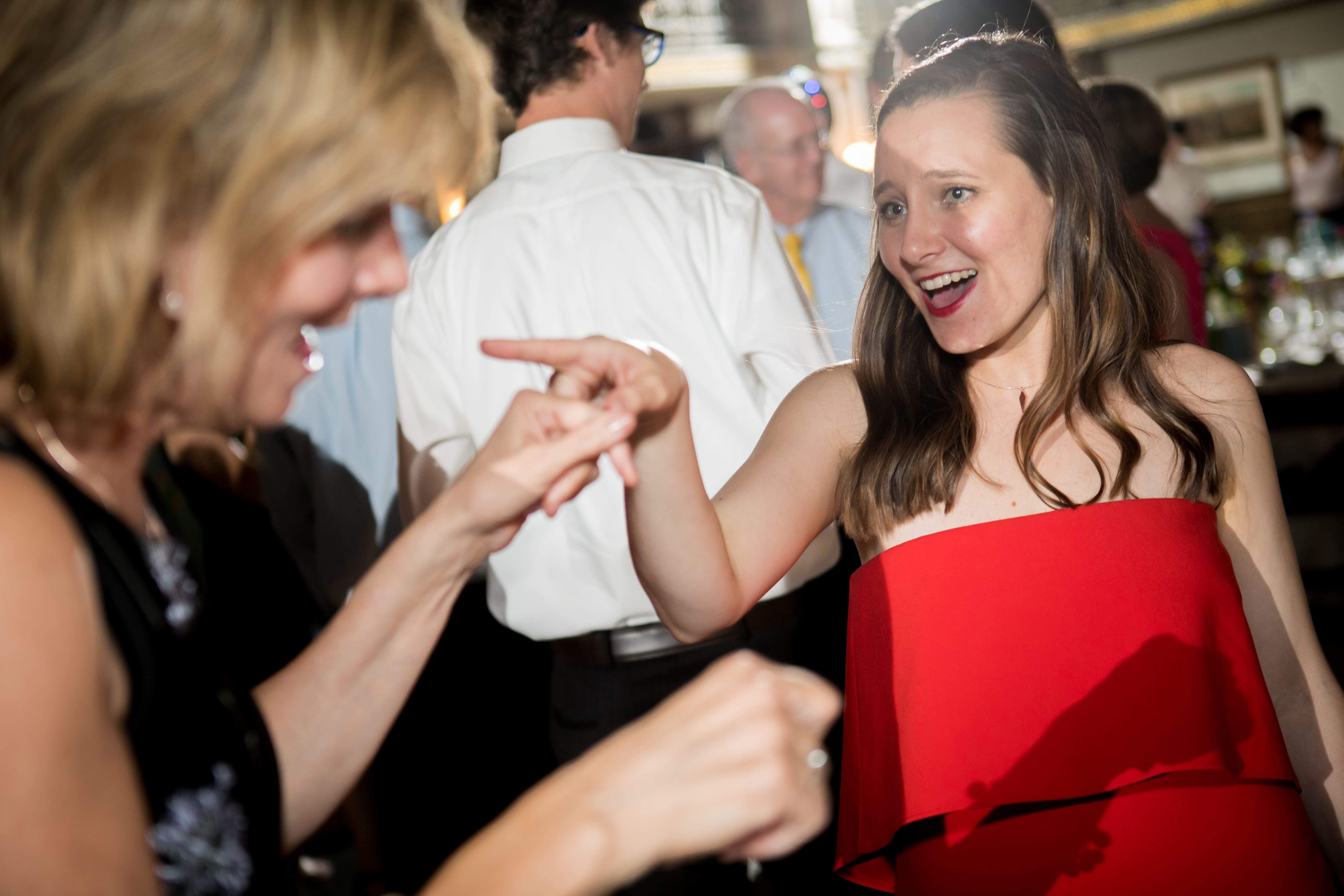 woman in red dress dancing at wedding
