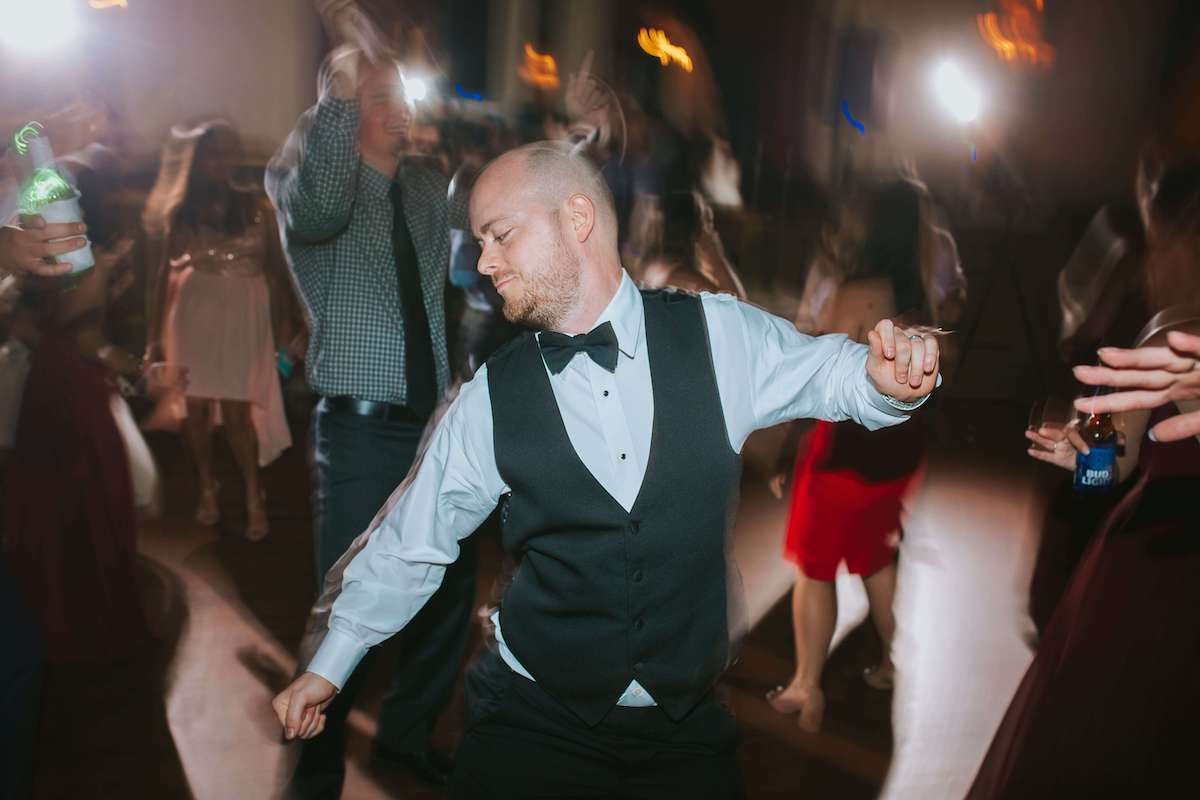 groomsman in tux dancing at wedding