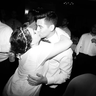 bride and groom kissing on dance floor