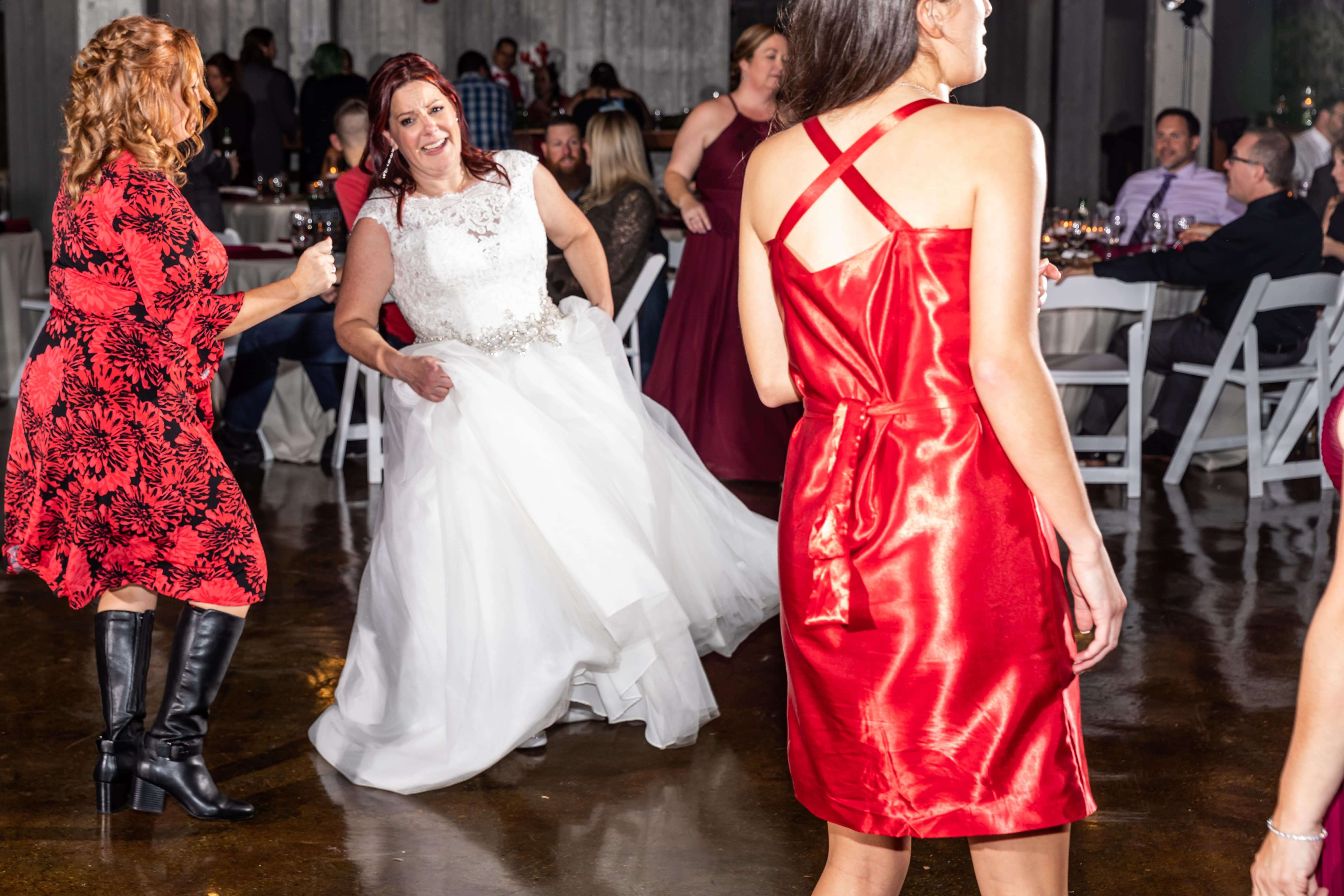 bride and friends dance