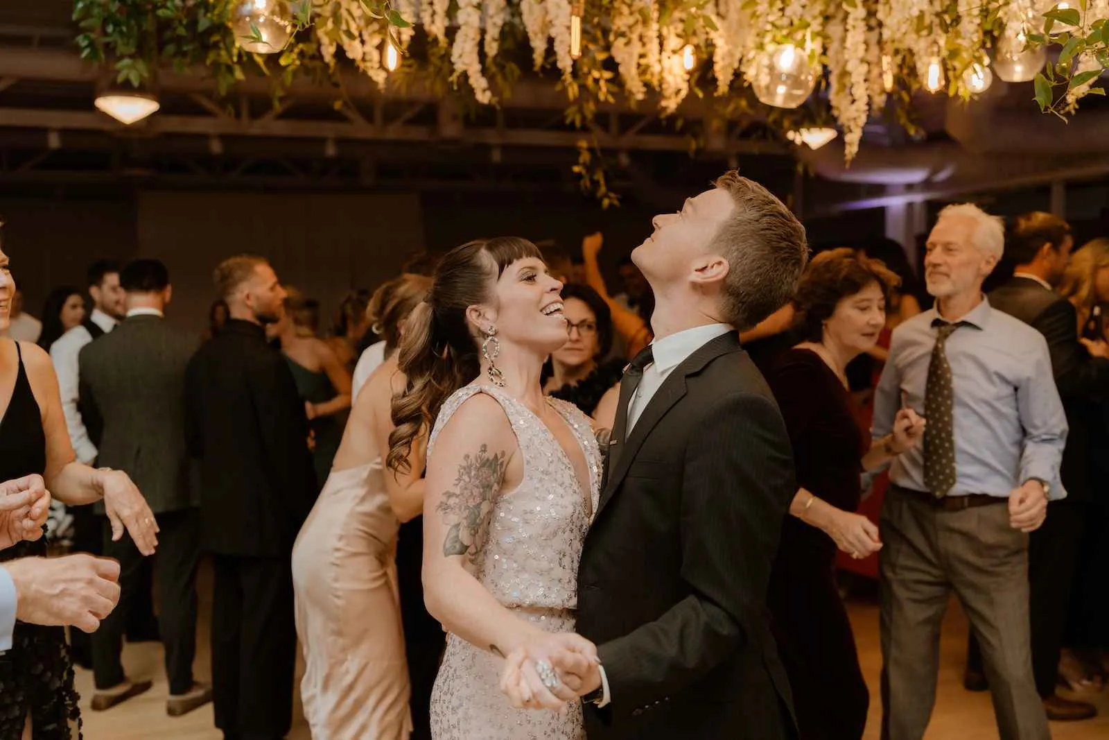 young couple slow dancing and smiling at wedding