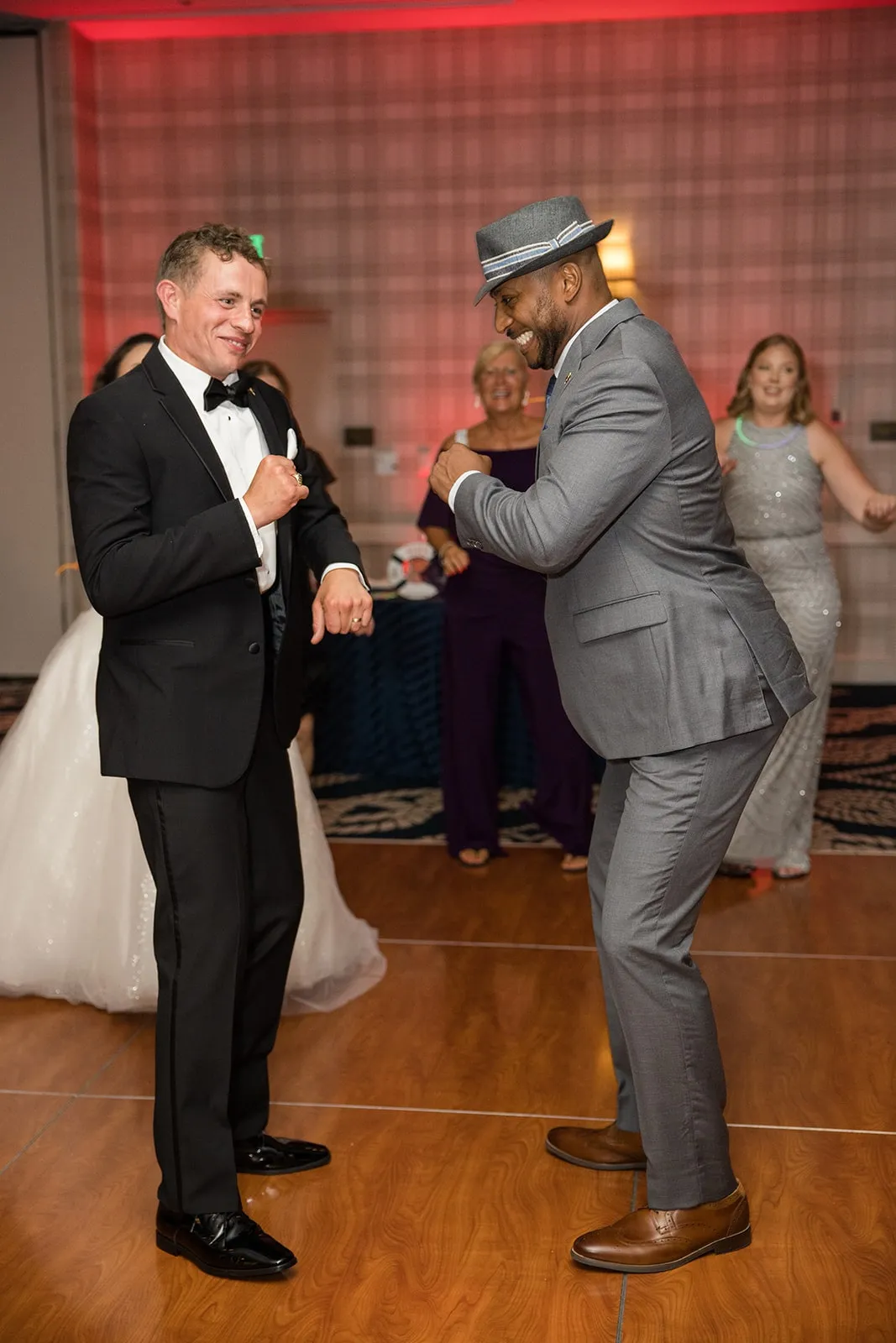 groom and guy dancing