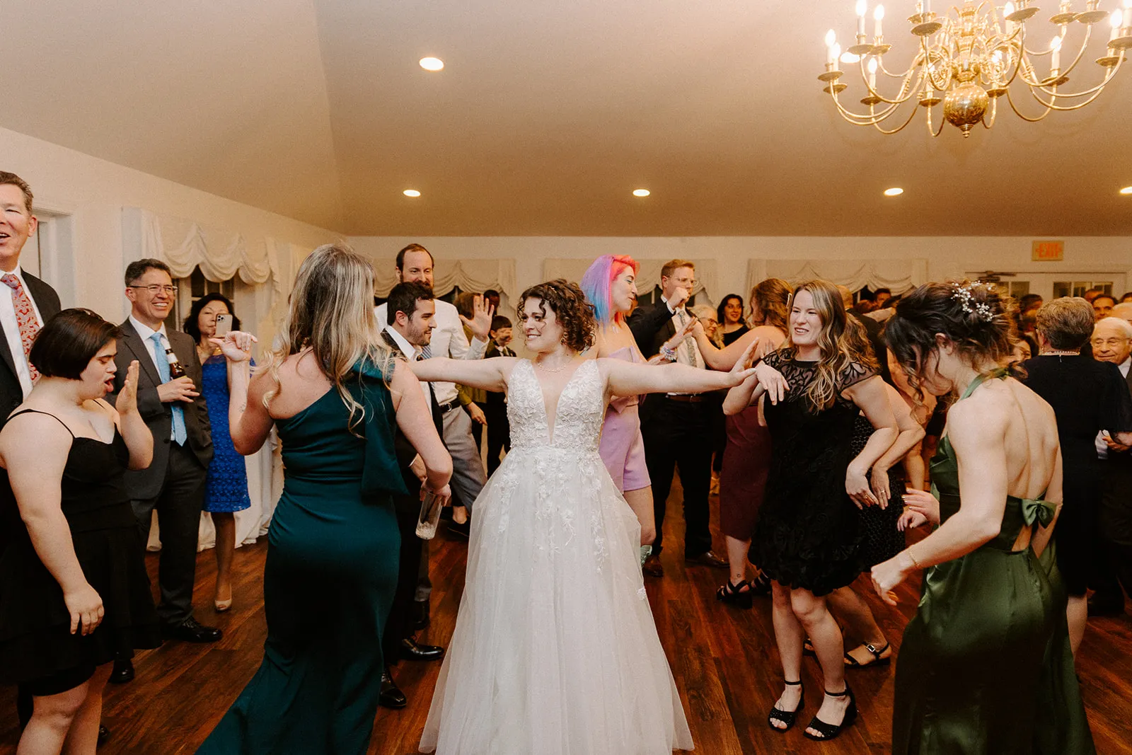 bride dancing with women