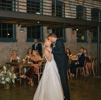 bride and groom kiss during first dance