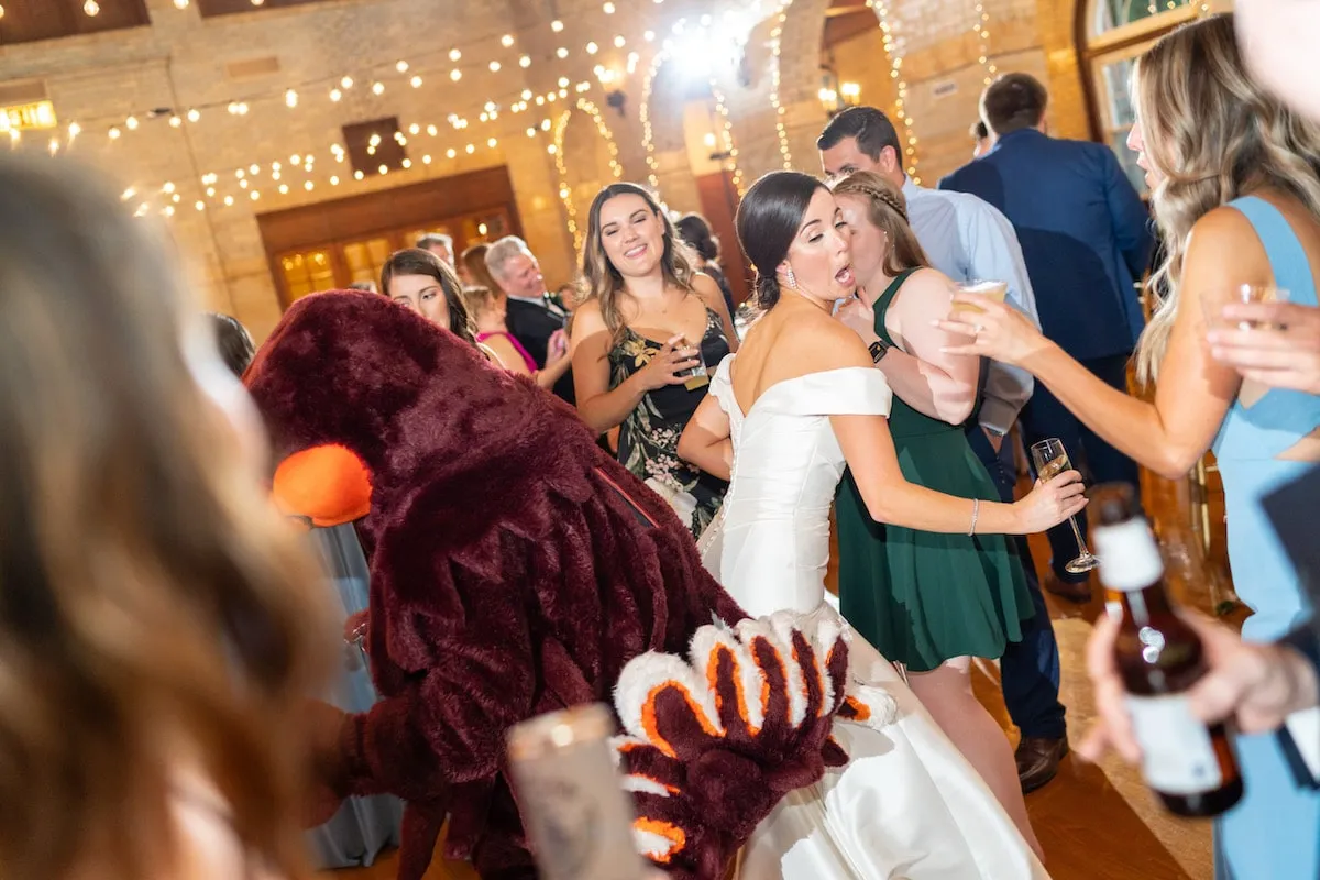 bride dancing back to back with the Virginia Tech mascot HokieBird