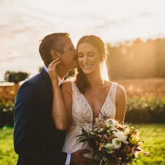 bride and groom pose in the sunset