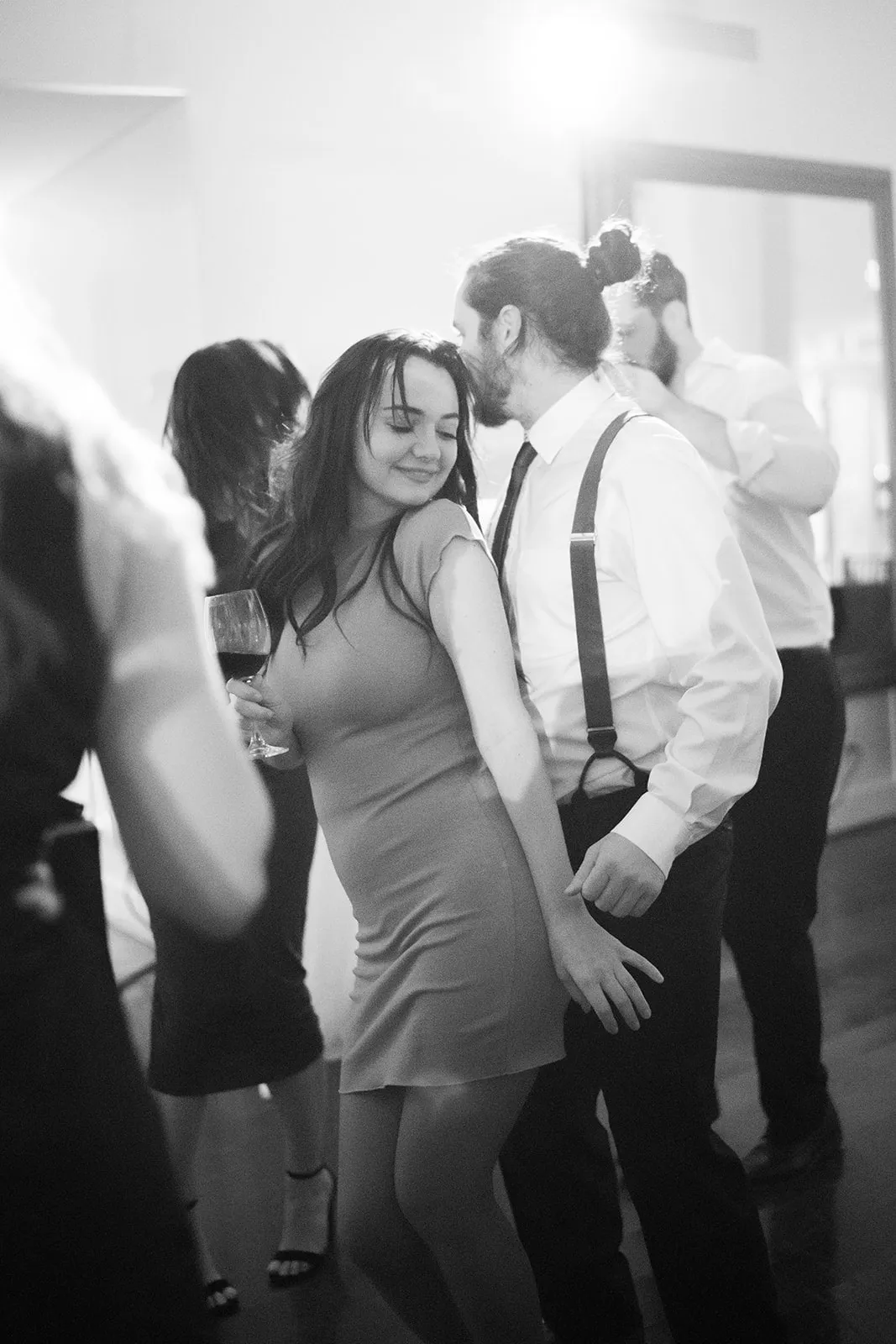 young couple dancing with woman in front