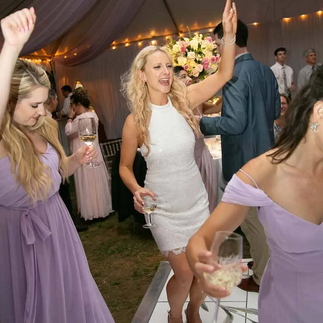 bride dancing with bridesmaids at wedding