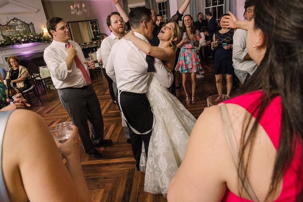 bride and groom dancing surrounded by guests