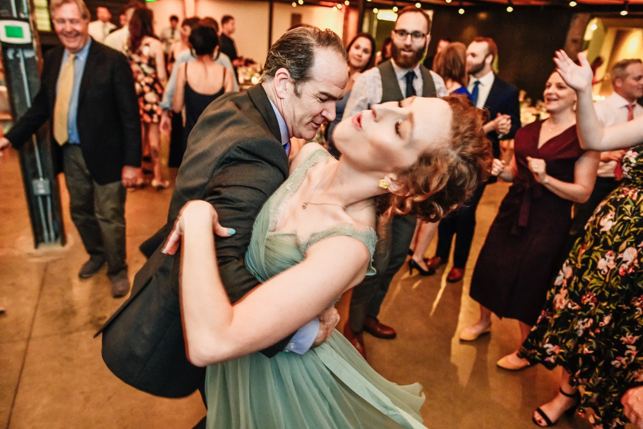 guy dancing with woman in green dress