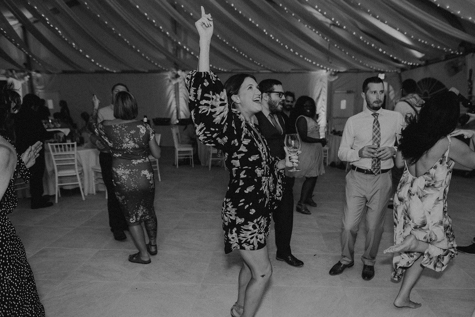 woman dances pointing her hand upwards