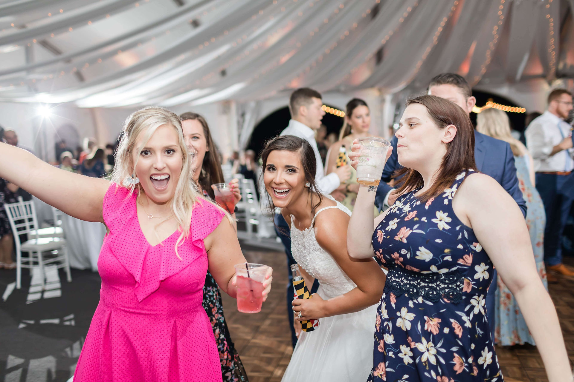 bride and friends dance