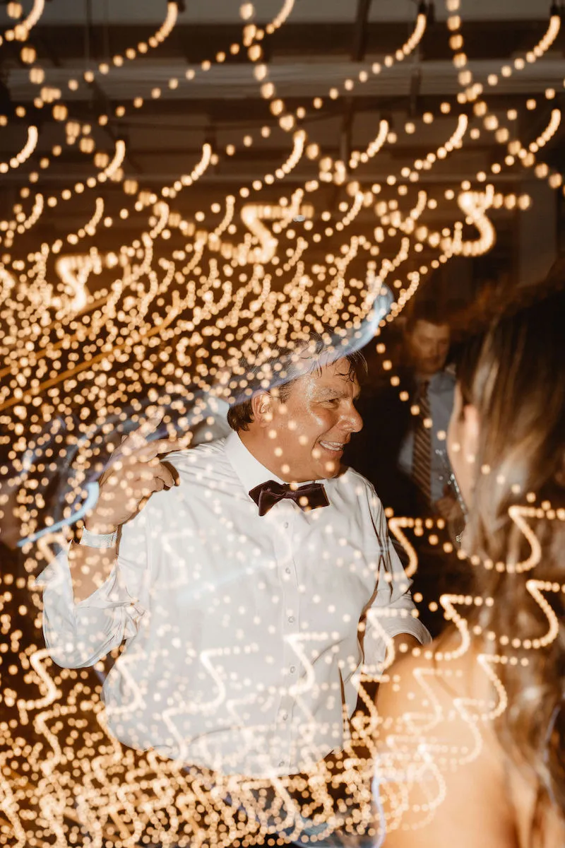 older man in bow tie and white shirt dancing