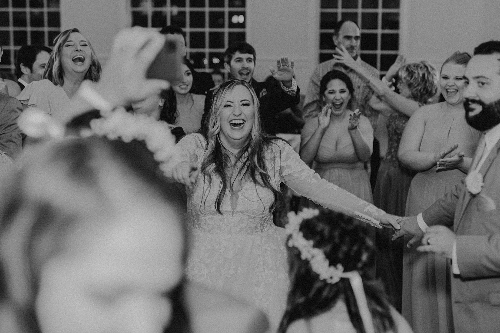 bride dancing with guests at wedding