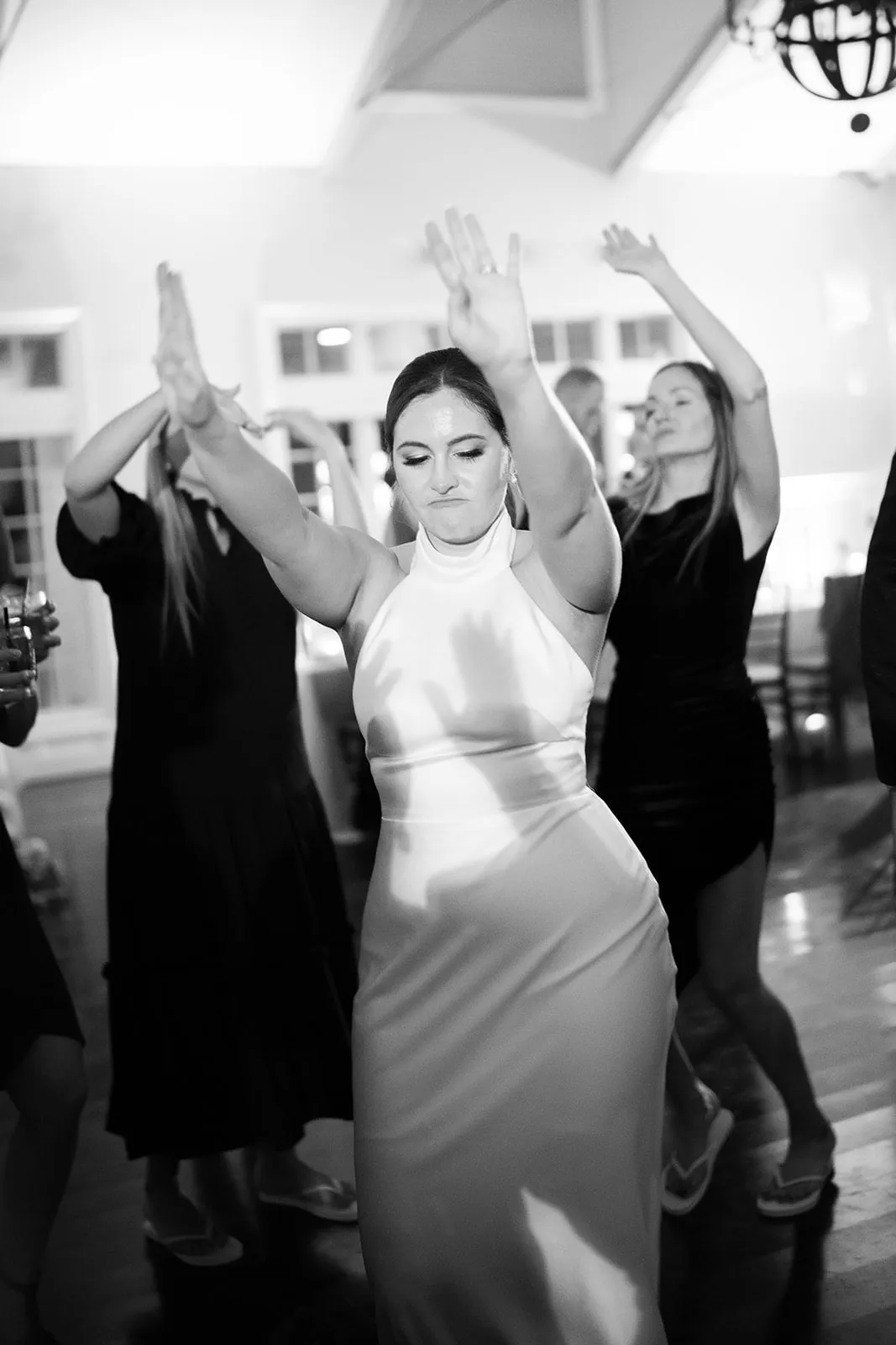 bride dancing with hands up