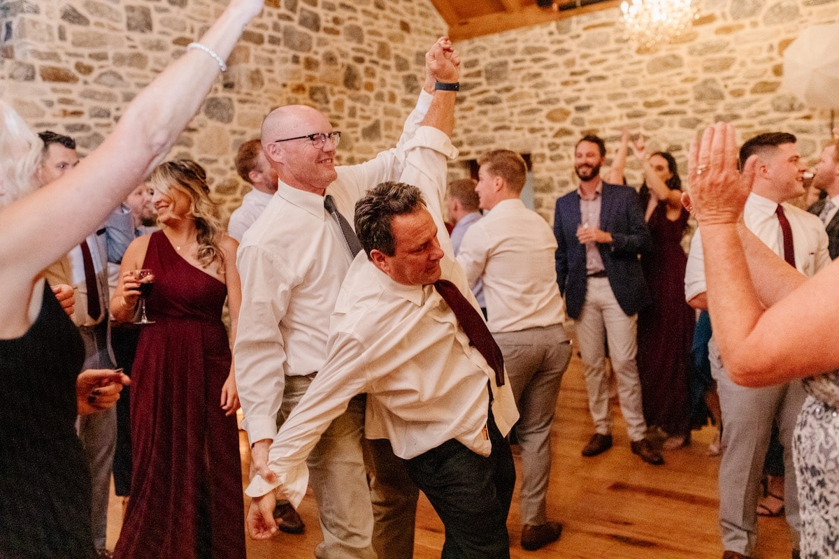 two men dancing at wedding