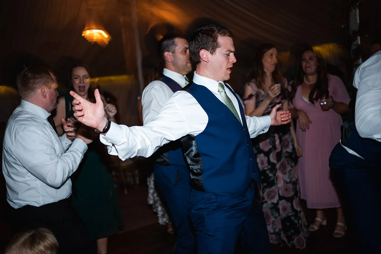 groomsman dancing with arms out