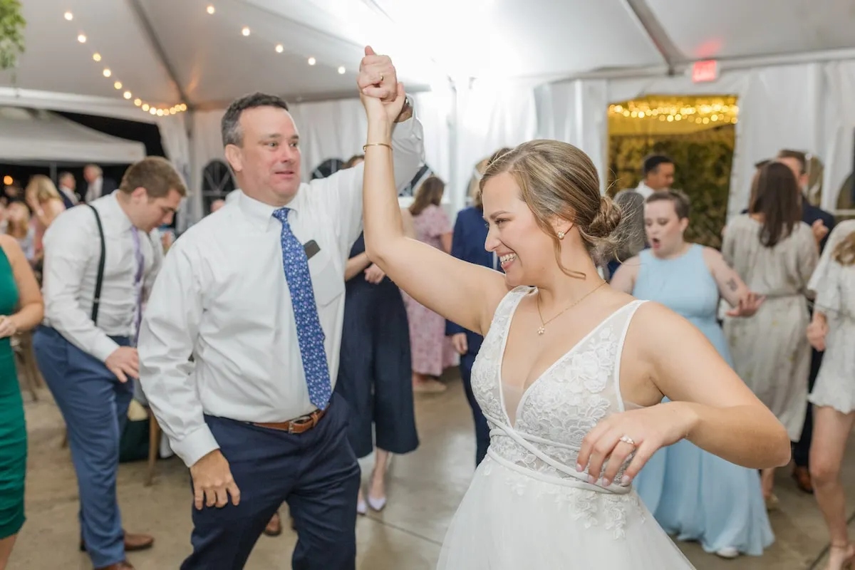 bride being spun by guy at wedding