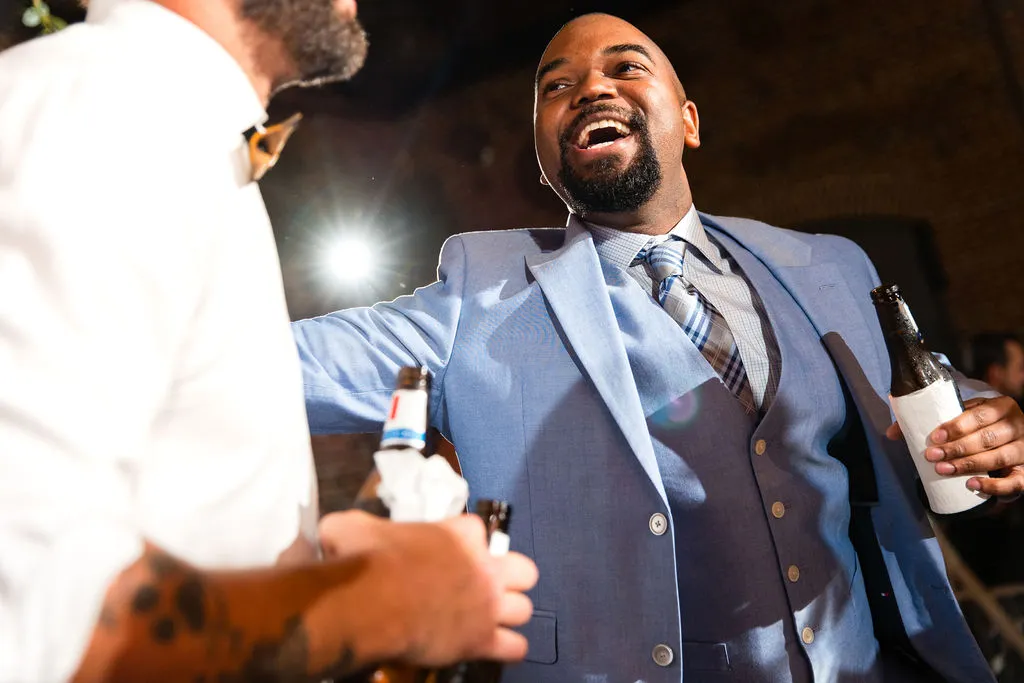 guy in light blue suit dancing at wedding