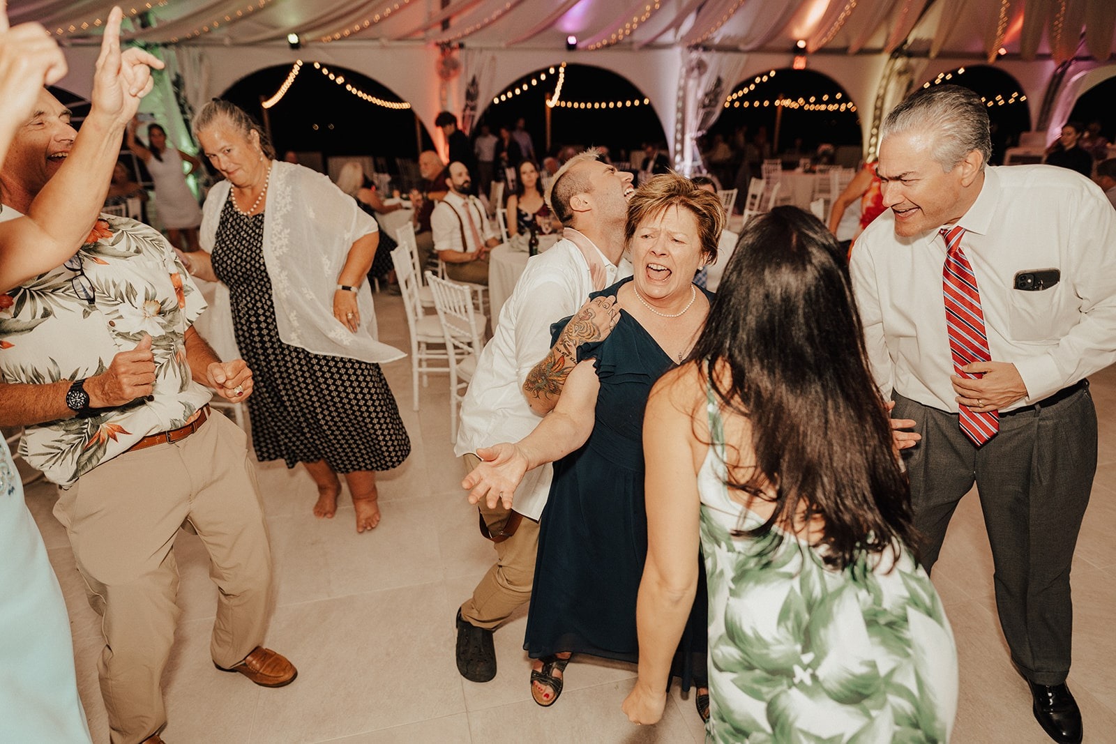mother dances with guests at wedding