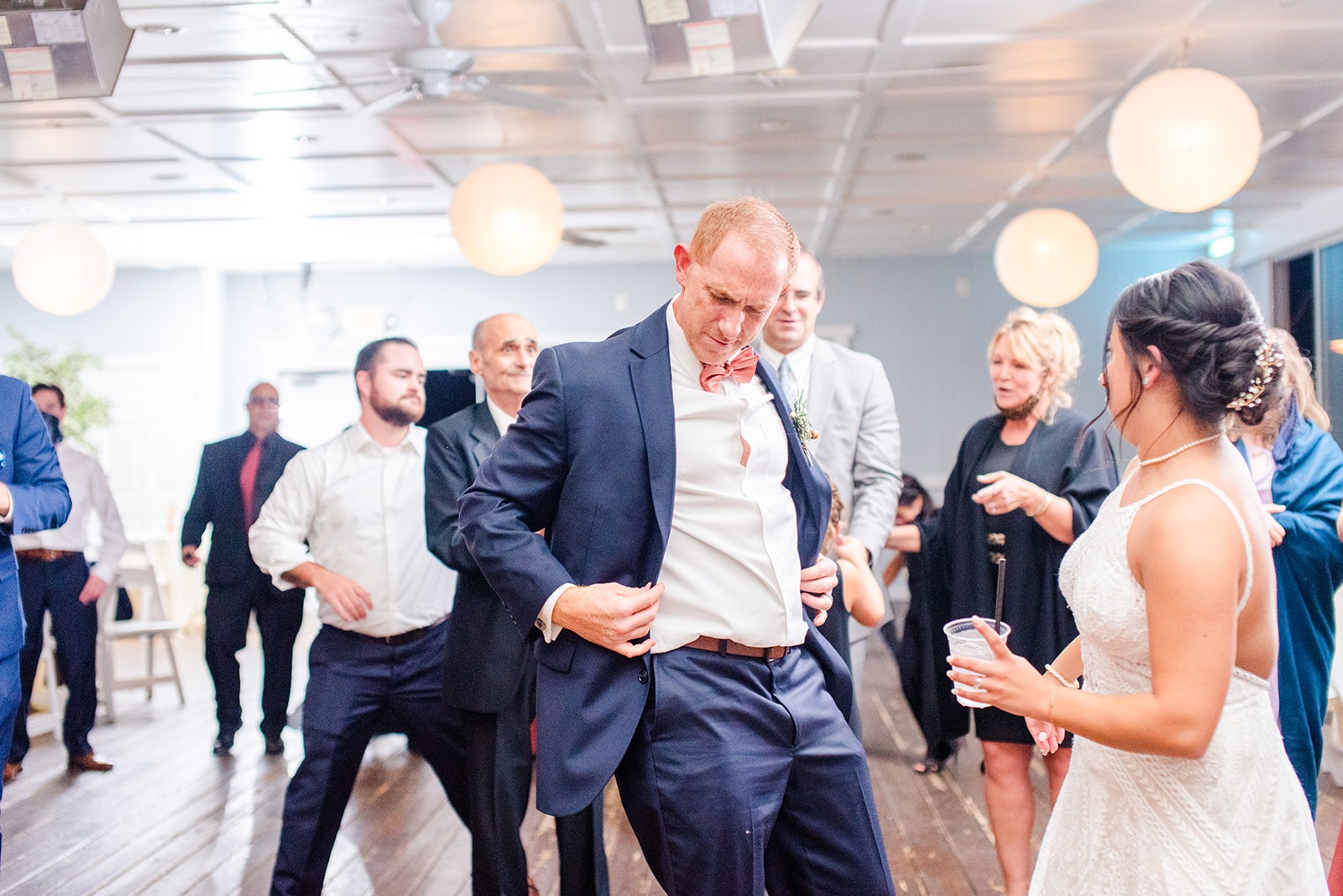 bride and groom dance with guests at wedding