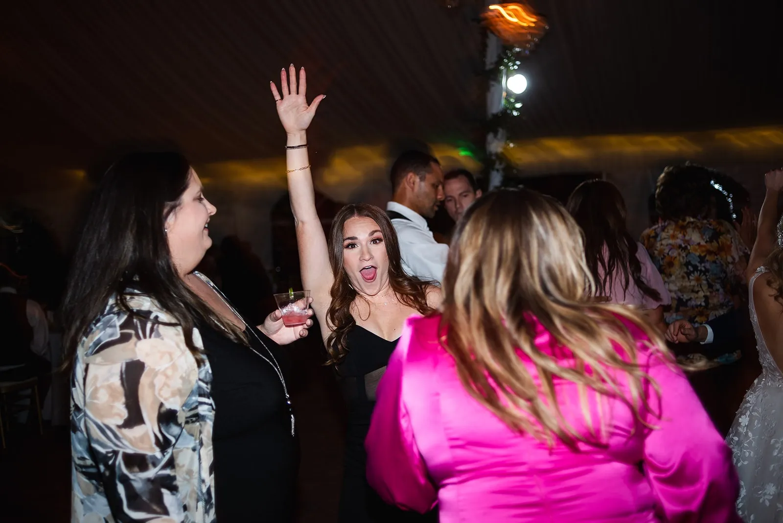 woman in black dress dancing with arm up