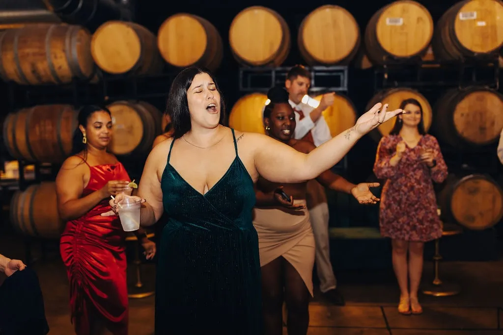 woman in black dress dancing and singing