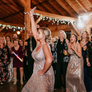 bridesmaid dances while surrounded by guests on dance floor