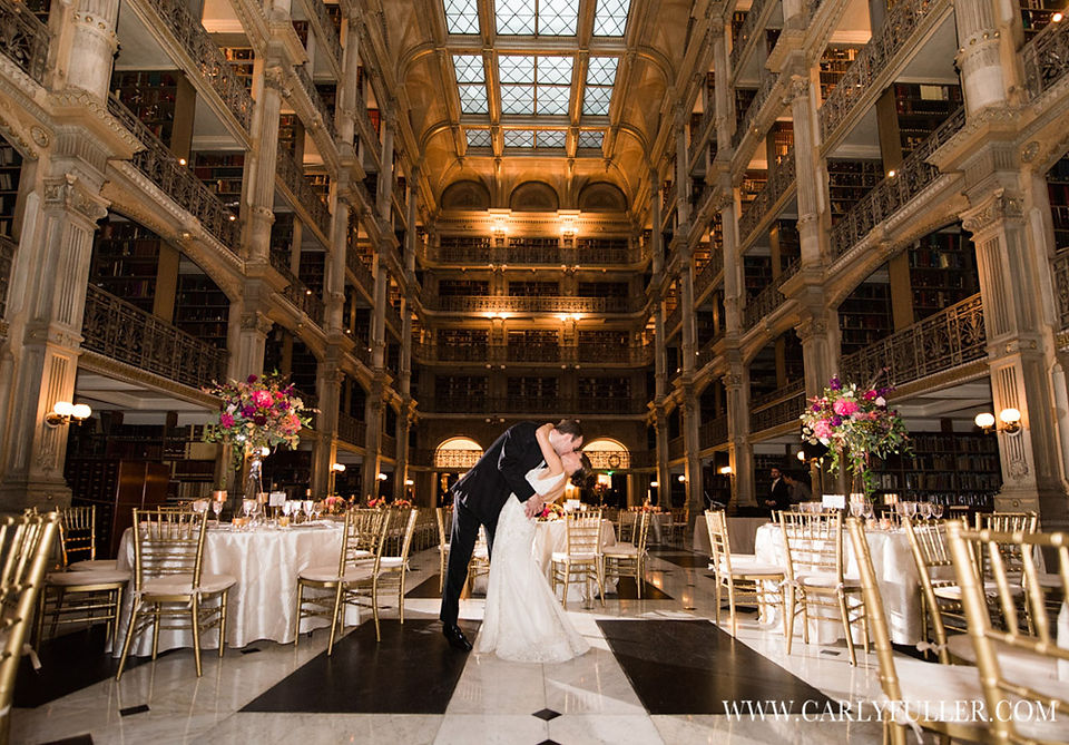groom kissing bride in library wedding setup