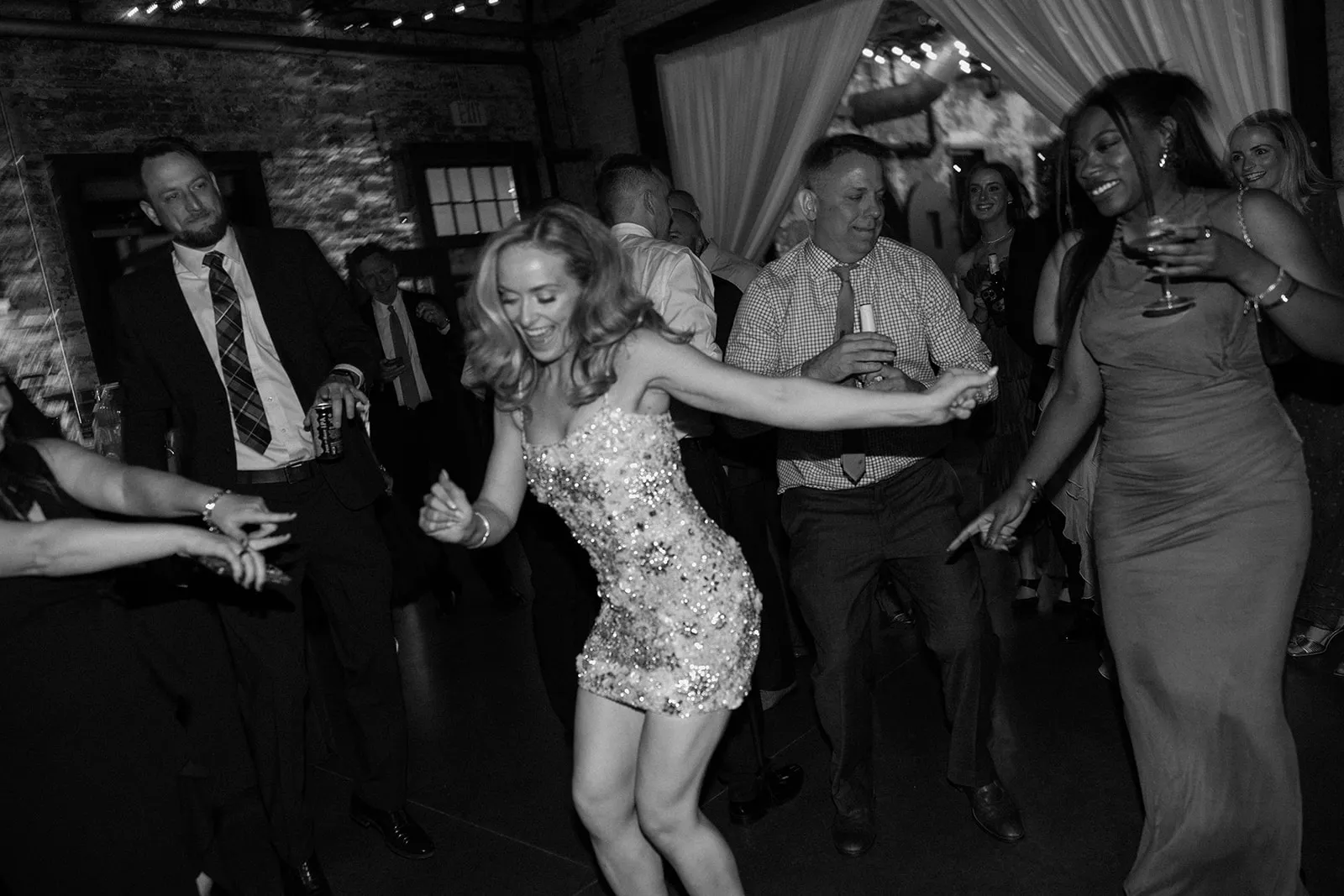 bride in short party dress dancing with guests